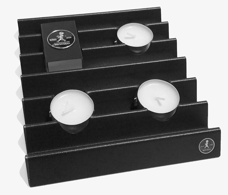 Ljushållare Zigzag Svart från Solstickan med vita ljus