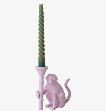 Foto av rosa apa-ljusstake med grönt spiralformat ljus