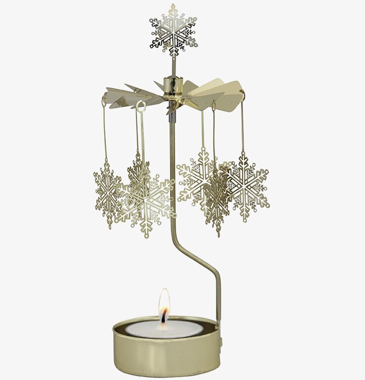 Bild av elegant ljuslykta med snurrande snöstjärnor