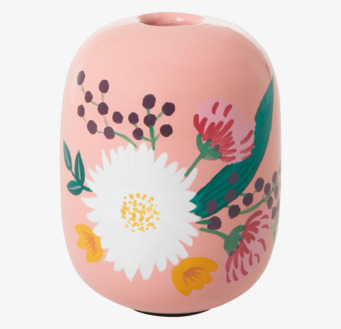 Bild av en aprikosfärgad ljushållare med blommotiv