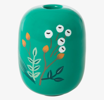 Foto av grön ljushållare med blommönster och glans