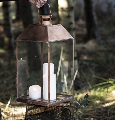 Bild av ljuslykta i naturlig och stämningsfull miljö