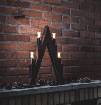 Bild av stämningsfull scen med ljusstake och tegelvägg