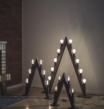 Bild av triangulära ljusstakar i varm inomhusmiljö