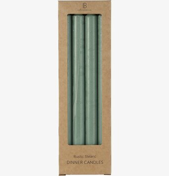 Bild av fyra gröna stearinljus i kartongförpackning