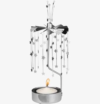 Bild av dekorativ ljuslykta med snurrande stjärnor