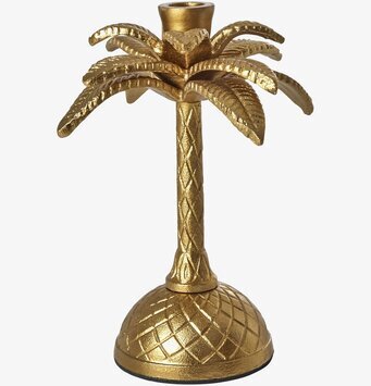 Bild av gyllene ljusstake med palminspirerad design