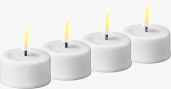 Bild på stilrena vita LED-värmeljus med varm glöd