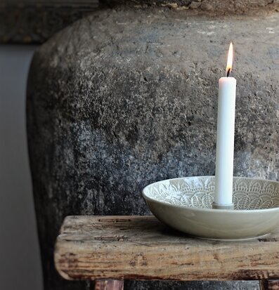 Bild av rofylld scen med ljuslykta och rustik kruka