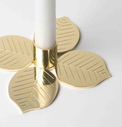Bild av stilren ljusstake med bladformade detaljer