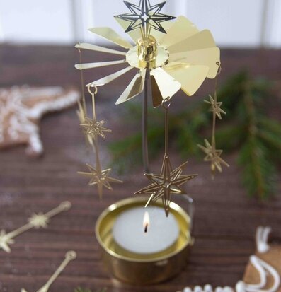 Bild av elegant änglaspel i guld med stjärndetaljer