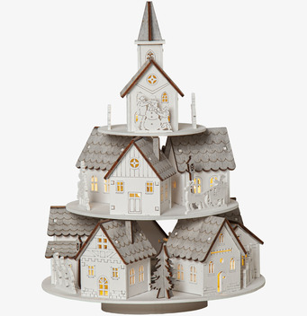 Bild av stämningsfull juldekoration med miniatyrby