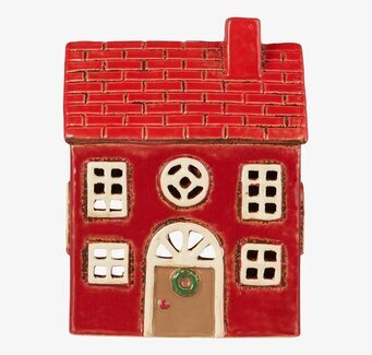 Bild av en charmig ljuslykta som liknar ett tegelhus