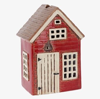 Foto av röd ljuslykta formad som ett hus i keramik