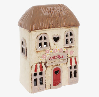 Bild av ljuslykta formad som en antikaffär i keramik