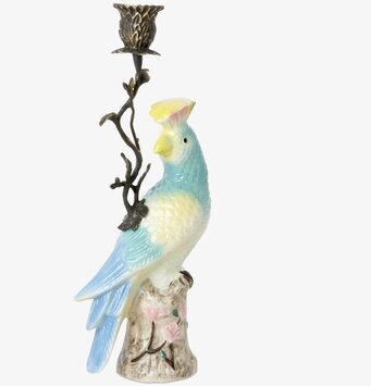 Bild av ljusstake med exotisk fågel och botaniska detaljer