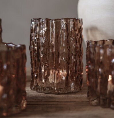 Bild av kastanjebrun ljuslykta i glas med vågig struktur