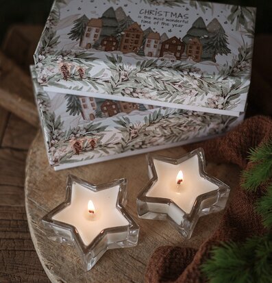 Bild av stämningsfull vinterinredning med doftljus och gran