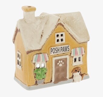 Foto av husformad keramikljuslykta med hundfigur