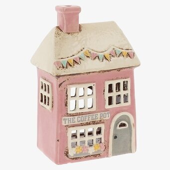 Foto: Rosa keramisk huslykta med butik och fönster