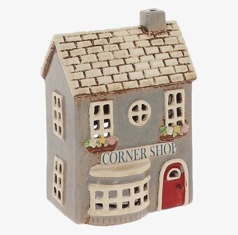 Foto av grått keramikhus med butik och fönsterlyse