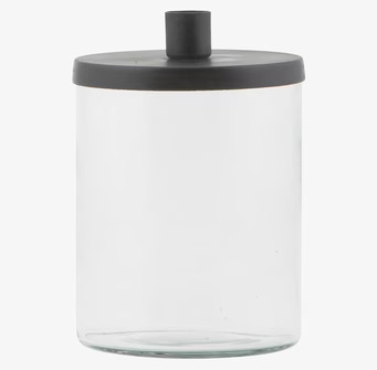 Foto av elegant ljusstake med glasbas och mörkt lock